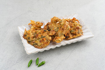 Bakwan sayur or bala-bala or vegetable fritter, Indonesian snack made from flour, cabbage, carrots and bean sprouts, served with chili or chili sauce. 
