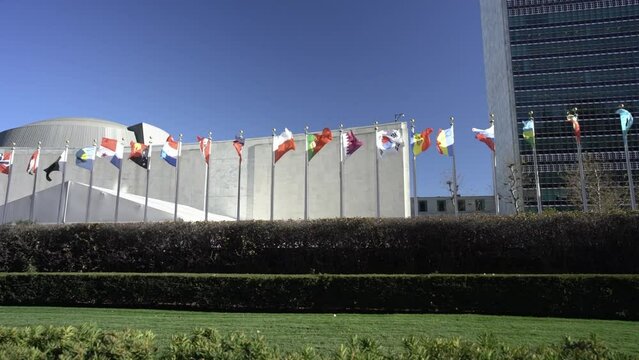 Flags flying at the United Nations Headquarter in New York City. Slow Motion flags in the wind. Qatar, Poland, South Korea flags