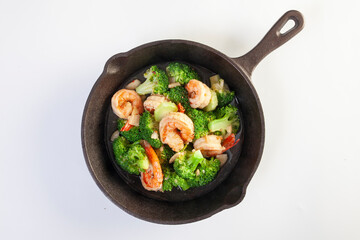 Stir fried broccoli and shrimp in a pan
