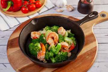 Stir fried broccoli and shrimp in a pan