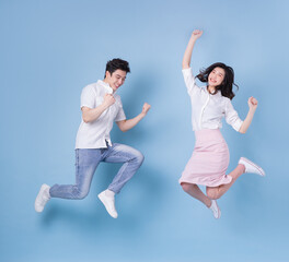 Fototapeta na wymiar Full length image of young Asian couple on blue background