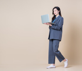 Full length image of young Asian business woman on background