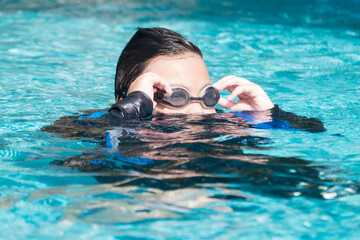 boy practicing swimming in the pool