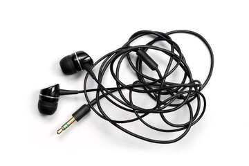 Headphones with a tangled wire on a white background.