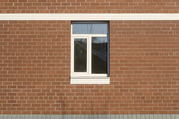 Front view of window exterior on new red brick wall