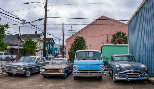 Front view of four vintage cars in a parking lot on Oak Street on April 5, 2022 in New Orleans, LA, USA