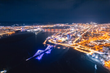 Aerial top view city Krasnoyarsk bridge through Yenisei river evening with neon light