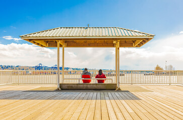 Couple relax by the sea and blue sky in the background. Beach resort Tropical pergola. Travel and vacation.