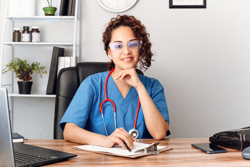 hispanic doctor woman with eyesight on clinic office looking at camera.