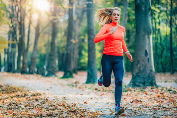 Woman Running in Public Park in the Fall.