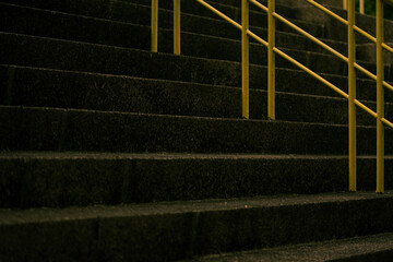 Yellow guardrails of an outdoor staircase.