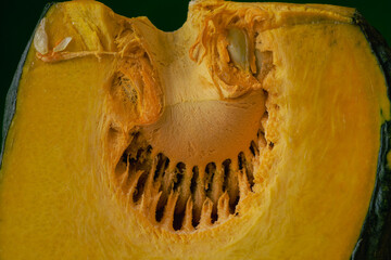 A wedge of smiling yellow pumpkin.