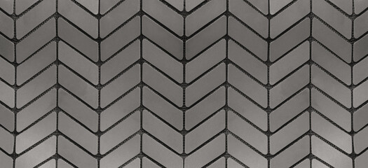 Gray metal arranged in geometric shapes background.