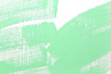 Green pattern of color paint brush on the white wall.