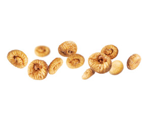 Delicious dried figs in the air on a white background
