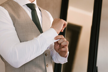Details of the groom's men's suit, hands close-up