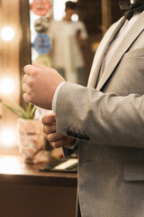 Details of the groom's men's suit, hands close-up