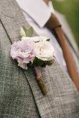 Details of the groom's men's suit,flower boutonniere close-up