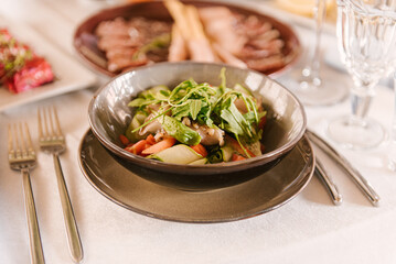 Festive table with food, plate with salad close-up