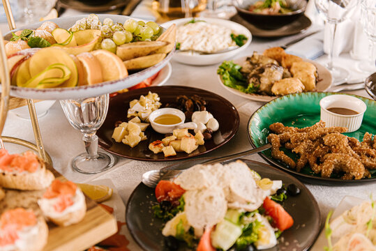 Festive table with food, buffet, bruschettas, cheese plate, fruits, selective focus