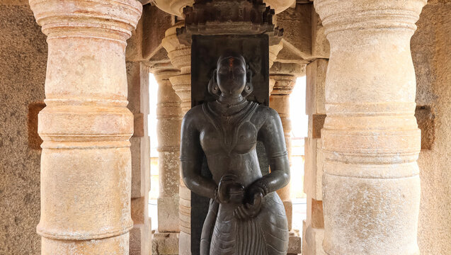 Gullakayajji or granny holding eggplant, 5ft tall statue opposite statue of Gomateshwara, Shravanabelagola, Karnataka, India