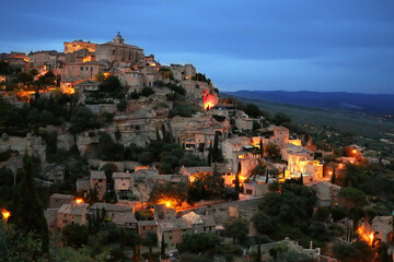 Fototapeta na wymiar Landscape of Gordes, a beautiful small French town in the late evening at the background of the night sky and lights
