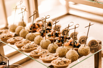 Festive buffet of the event, many appetizers canapes and bruschettas on glass coasters