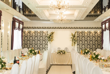 Hall decor for events, wedding decor, presidium and tables for guests with flowers, table decor elements