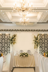 Hall decor for events, wedding decor, presidium and tables for guests with flowers, table decor elements