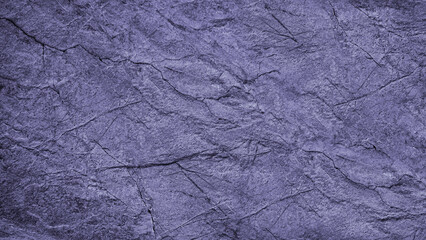 Dirty purple grunge background. Toned rough cracked rock surface texture. Close-up. Blue stone background with space for design.