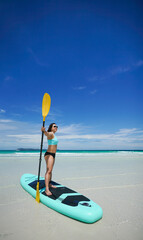 woman on sup board at the beach
