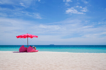 Pink parasol and  seat on the tropical beach