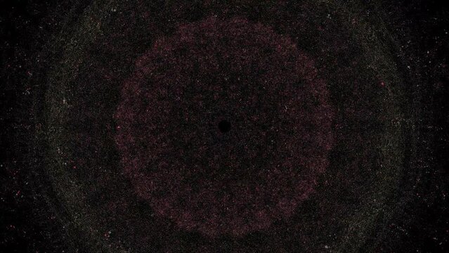 Slowly evolving spiral particle pattern on black background appears, rotates then fades to black