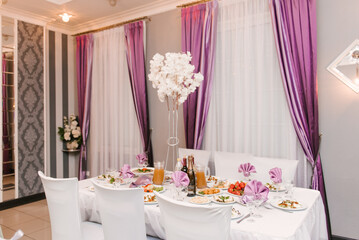 Hall decor for events, wedding decor, presidium and tables for guests with flowers, table decor elements