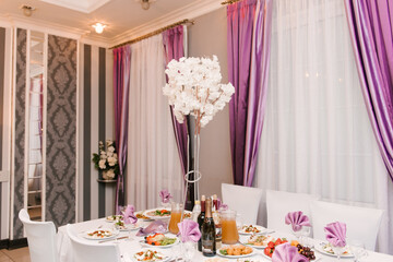 Hall decor for events, wedding decor, presidium and tables for guests with flowers, table decor elements