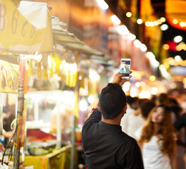 He just had to get a picture. Rearview shot of a young man taking pictures while touring a foreign city.