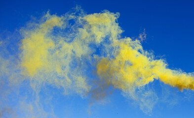 Yellow smoke on a blue background.