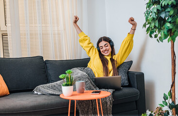 Rested caucasian girl, relaxing at home, watching a movie on laptop.
