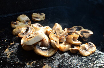 fried White organic Mushrooms. plant based cooking ingredients. vegan and vegetarian cuisine. food preparation