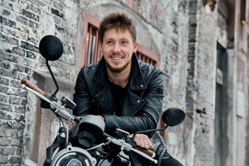 Fototapeta na wymiar Biker with modern motorcycle having a break in the city.