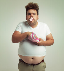 Must have more marshmallows. Shot of an overweight man with marshmallows shoved in his mouth.