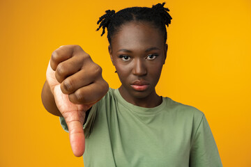 Young african american woman showing a dislike gesture
