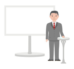 大きなパネルと原稿が乗ったテーブル傍に立つ男性アナウンサー
