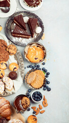 Dessert table with all kinds snacks on light background.