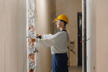 Women foreman architect check work of construction worker with drawing print apartment