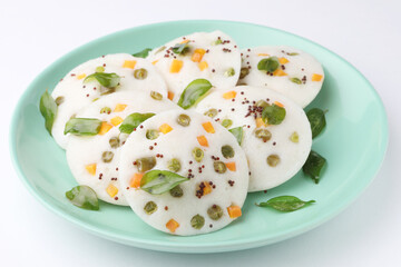 vegetable idli served with coriander and coconut chutney with tomato sauce