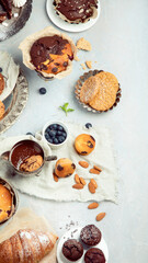 Dessert table with all kinds snacks on light background.