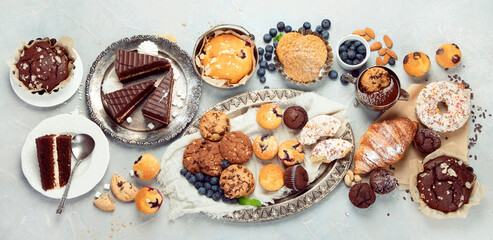 Dessert table with all kinds snacks on light background.