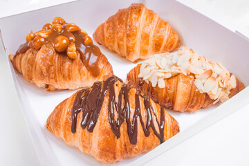 Croissant in the box  for delivery order , isolated background