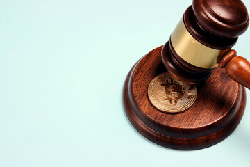 Judge or auction gavel and bitcoins on a blue background. Cryptocurrency legislation. Internet...